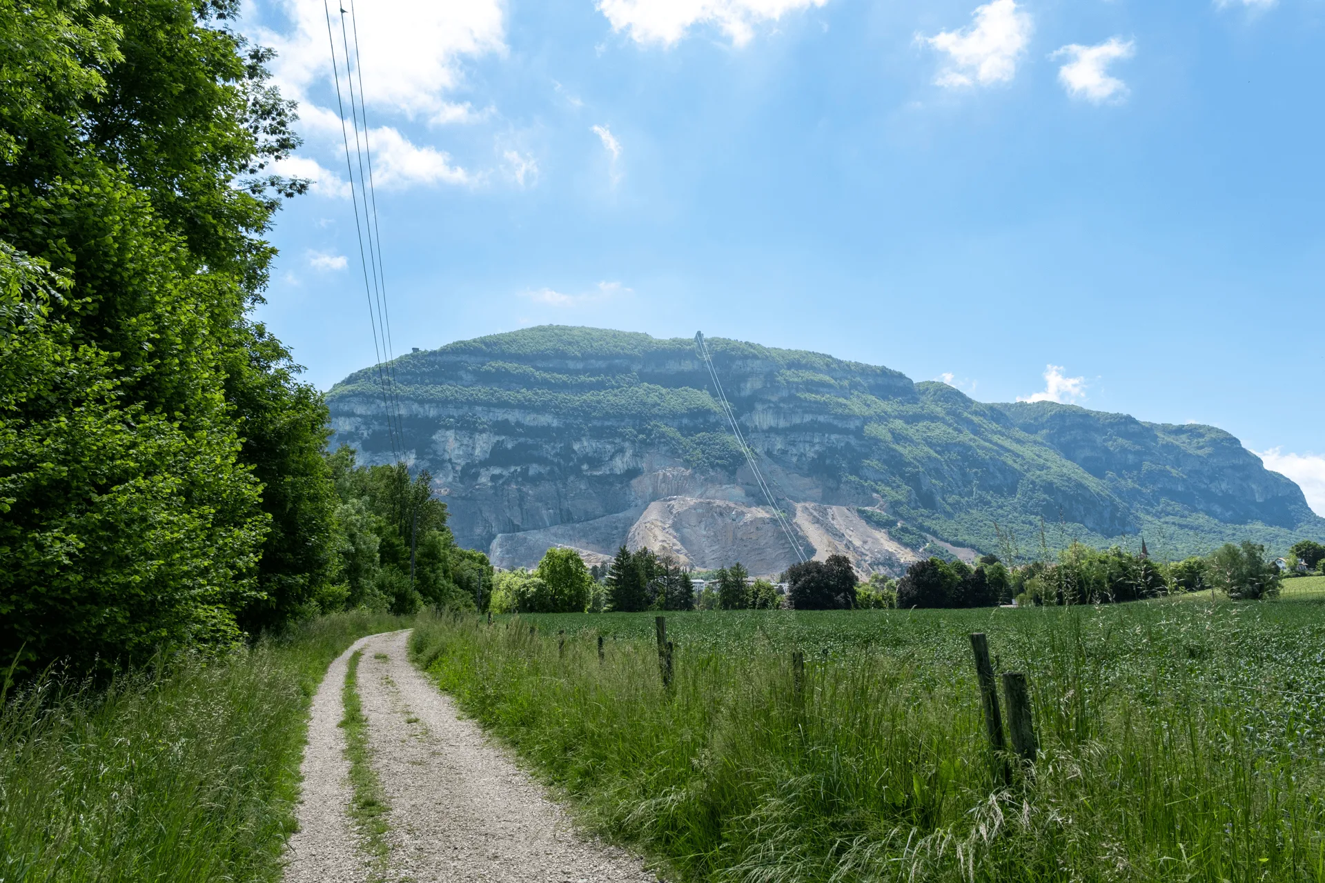 "A view of Mont Salève mountain with lines of the cable car visible"