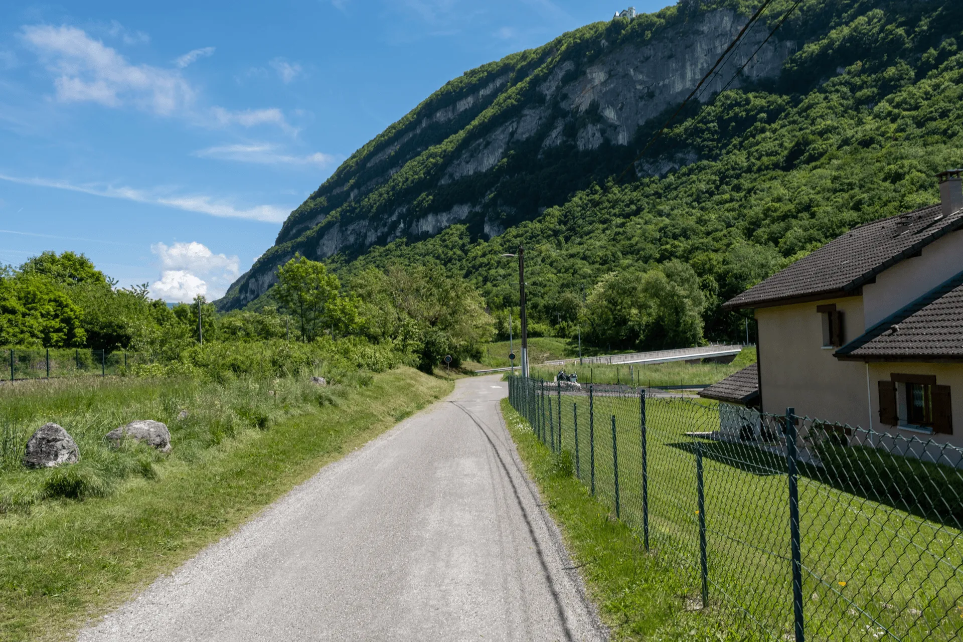 "A road past a house."