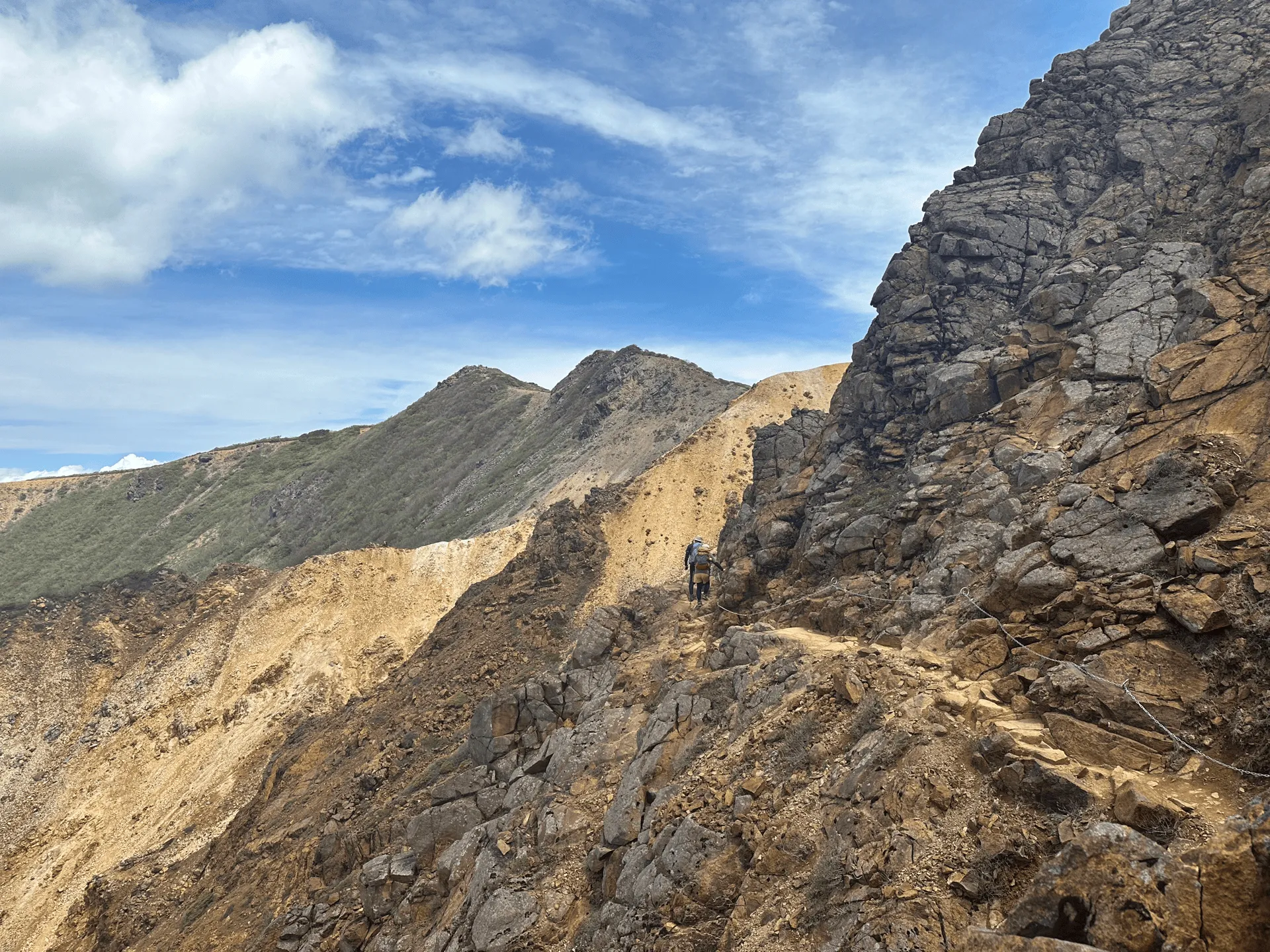 The trail has a bit where you hold onto a chain and walk along a narrow path.