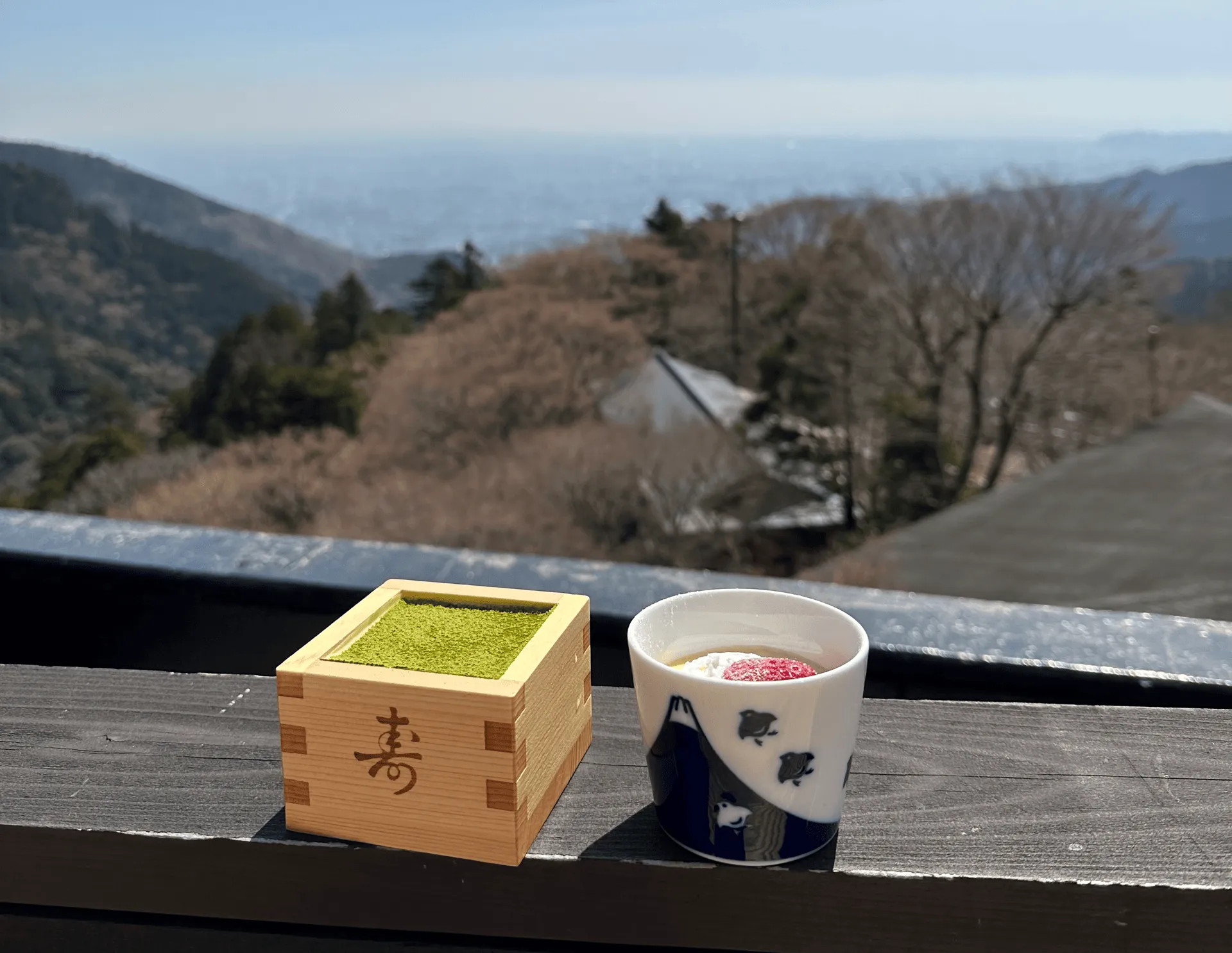 The matcha tiramisu is dusted green with a cute wooden container