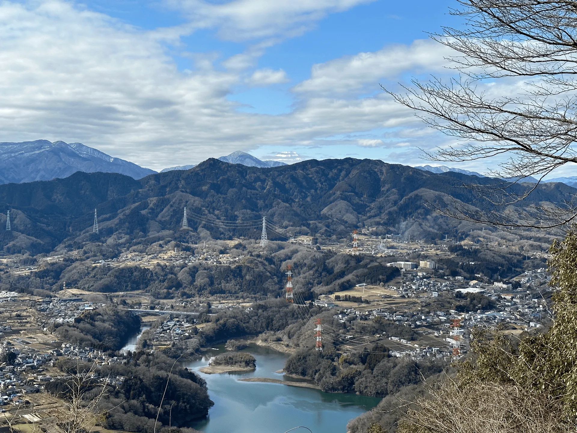 A glimpse of Mt Fuji in the distance, with a lake in the foreground below